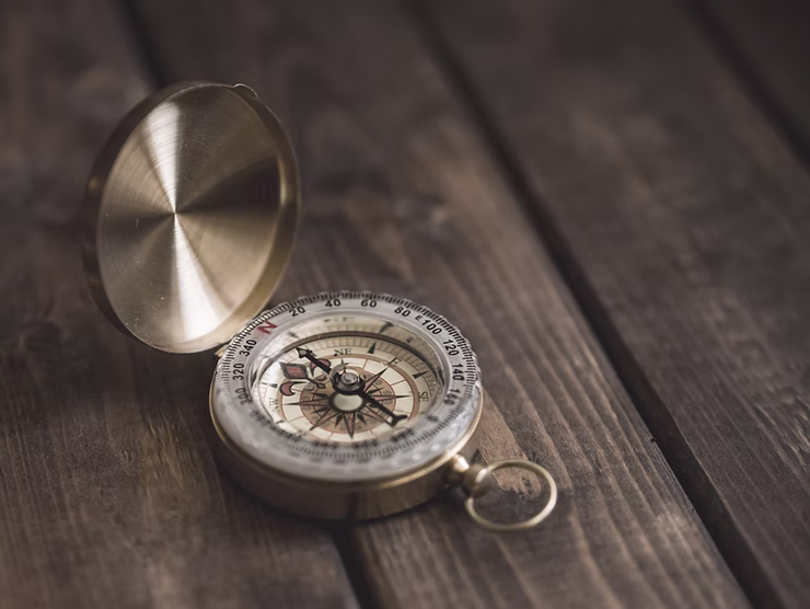 Compass sitting on a wooden table